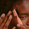 A 3-in-1 beauty tool for baby hairs, edges, and flyaways that has a comb to separate and smooth, a natural boar bristle brush for shaping, and a pointed tip for parting and finishing your style.