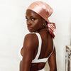 A satin headscarf that can be worn during the day and night that helps to protect hair from breakage, frizz, and tangles.