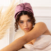 An ultra-lightweight satin hair wrap with a no slip design that protects smaller heads and fine hair from environmental stressors during the day and from sheets at night.