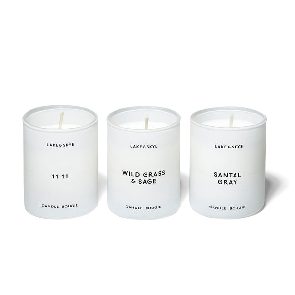 A trio of mini candles that include the 11 11 in notes of white ambers and musk, Santal Gray in notes of sandalwood and violet leaf, and Wild Grass & Sage in notes of lemon leaves and sage.